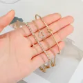 Elegantes goldenes mehrlagiges Armband-Set mit Herzanhänger, Strasssteinen und Perlen - 4-teiliges Knoten-Herz-Strass-Set (5806201) / 4er-Set / Gold