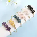 Close-up detail of assorted natural raw gemstone wire-wrapped golden open cuff bangles - White Crystal