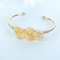 Handmade gold wire wrapped cuff bracelet with three raw yellow stones detail view - Citrine