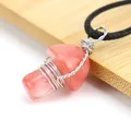 Detail of handmade wire-wrapped pink mushroom pendant on bamboo texture - Watermelon red