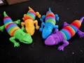 Close-up of four colorful rainbow lizard fidget toys designed for effective stress relief - Light-up Lizard / Light-up Lizard