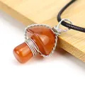 Macro detail shot showing the intricate silver wire-wrapped orange mushroom pendant - Red Agate