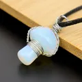 Macro view of handmade silver wire-wrapped mushroom pendant with opalite-like stone. - Opal