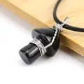 Macro view of a handmade wire-wrapped black stone mushroom pendant jewelry piece - Obsidian