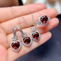 Close-up view of elegant silver jewelry set with heart-cut red garnet stones and halo - Red 3-Piece Set (TZ-17)