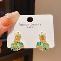 A close-up detail shot of luxury green flower drop earrings with zircon crystals on a card - S925 Silver Stud Earrings (HE28296-3) / Blue