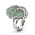 Detail view of an oval green crystal ring wrapped in silver tree of life wire pattern. - Adjustable Open / Green Aventurine