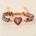 Close-up of handmade woven bracelet with a red heart-shaped imperial stone focal. - Red Imperial Heart
