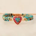 Close-up detail of a handmade woven imperial stone bracelet with heart-shaped stone charm - Turquoise Blue Heart