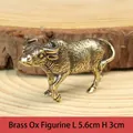 Detailed close-up of a vintage brass bull figurine with intricate textures on wood - Ox Zodiac Figurine / Approx 52g