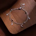 Elegantes silbernes doppellagiges Armband mit funkelnden Stern- und Mondsichelanhängern - Stern Mond Doppelreihiger Stil