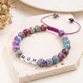 Close-up of handmade jasper bead bracelet featuring white letter beads spelling MOM. - MOM (Woven Style) / Adjustable