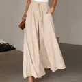 Detailed view of high-waisted wide-leg trousers with elastic waistband and drawstring. - S / Bottoms / Apricot