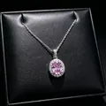 Macro detail of elegant oval pink gemstone pendant with sparkling halo on silver chain. - Pendant Necklace (T16) / Pink