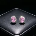 Detail of elegant pink oval moissanite stud earrings with a halo of clear stones - Earrings (T16) / Pink