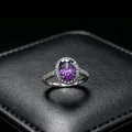 Close-up detail of an elegant oval purple moissanite ring with a sparkling halo setting - Ring (T16) / Purple
