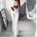 Detailed view of white high-waisted flared yoga pants featuring a slim fit commuting style - S / Bottoms / White