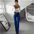 Model wearing blue high-waisted flared yoga pants and white long sleeve bodysuit detail - S / Bottoms / Blue