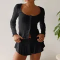 Close-up of black ribbed fabric details with lettuce edge trim and button-up front - S / Top And Bottom / Black