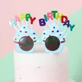 Close-up of cute cupcake shaped birthday party glasses with festive decorations - Blue Ice Cream Glasses