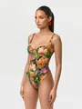 Detailed view of a vibrant floral print one-piece bodysuit worn by a professional model. - S / Tops