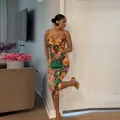 Fashionable floral print sleeveless bodysuit worn by a model in a summer indoor setting. - S / Top And Bottom