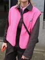 Close-up of vibrant pink fleece vest with snap buttons and small chest patch detail - S / Tops / Rose Red