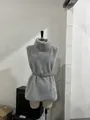 Close-up detail of stylish gray faux fur vest with high neck and waist belt on mannequin - S / Tops / Gray