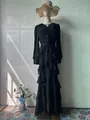 Detailed view of an elegant black tiered maxi dress featuring ruffles and long sleeves - S / Dresses / Black
