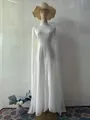 Elegant white long-sleeve maxi dress with cape sleeves on a mannequin for Fall 2025 - S / Dresses / White