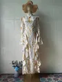 Elegant long sleeve floral maxi dress with ruffled hem and slim fit on mannequin - S / Dresses / Yellow Flower