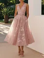 Detail shot of a dusty pink sleeveless V-neck floral print dress with a bow waist. - Deep Pink