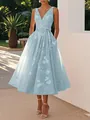 Elegant light blue floral V-neck midi dress with bow-tie waist shown in a sunny garden. - S / Sky Blue