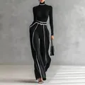 Detail view of black turtleneck and wide-leg trousers set with elegant white stripe accents. - XS / Top And Bottom / Black