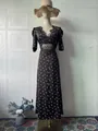 Elegant retro polka-dot long dress with delicate black lace v-neck detailing on mannequin - S / Dresses / Dark Brown