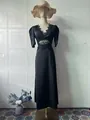 Detailed view of elegant black V-neck dress featuring delicate lace trim and cut-out waist - S / Dresses / Black