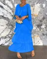 Detailed view of a bright blue tiered maxi dress featuring a loose fit and round neckline - S / Top And Bottom / Blue