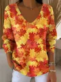 Detailed view of women's V-neck top with vibrant red and yellow maple leaf print - S / Tops / Maple Leaf Print (Pattern 6)