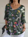 Close-up of a green V-neck T-shirt with vibrant floral print and 3/4 sleeves - S / Tops / Dark Green Wildflower Print (Pattern 7)