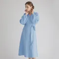 Close-up of a light blue crinkled wrap dress featuring a stylish tie-waist design - S / Dresses / Sky Blue