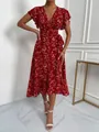 Close-up detail of a red floral print wrap dress featuring butterfly sleeves and a ruffled hemline. - S / Dresses / Red