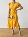 Close-up of yellow floral wrap dress with ruffled hem and butterfly sleeves - S / Dresses / Yellow