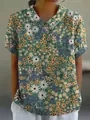 Detailed view showing the vibrant yellow and white floral print pattern on casual shirt - S / Tops / Floral Pattern (Yellow and Purple)