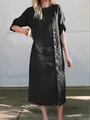 Detailed view of casual black midi dress featuring a round neck and side decorative buttons. - S / Dresses / Black