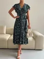 Close-up of a dark green floral wrap dress with butterfly sleeves and a ruffled hem. - Green