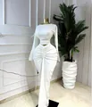 Elegant white two-piece set featuring a long sleeve crop top and ruched maxi skirt - S / Top And Bottom / White