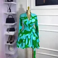 Detailed view of turquoise and lime green printed wrap dress with ruffle hem on mannequin - 3XL / Dresses / Green