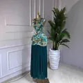 Elegant sleeveless tie-dye print maxi dress featuring a teal pleated skirt on mannequin - S / Dresses / Lake Blue