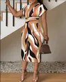 Elegant V-neck slim-fit midi dress with bold abstract print and chic silhouette - S / Dresses / Coffee Print