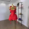 Detailed view of red sleeveless satin dress with 3D floral appliqués on a mannequin - L / Dresses / Red